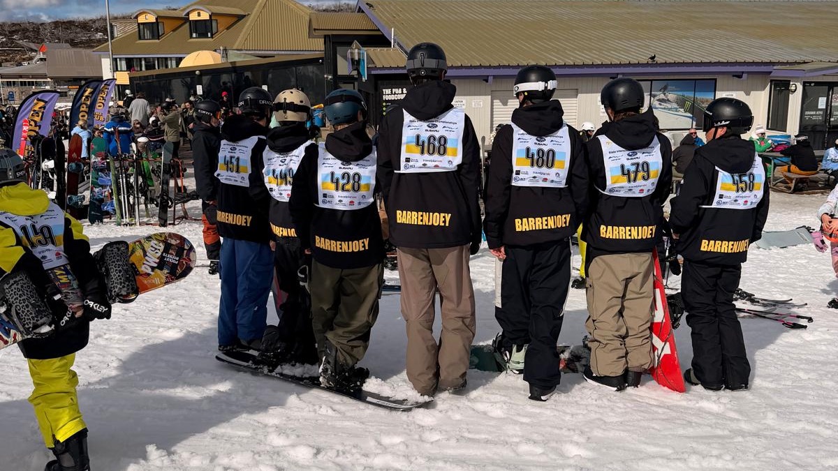 Barrenjoey Snowsports team members from behind in their black BARRENJOEY jackets